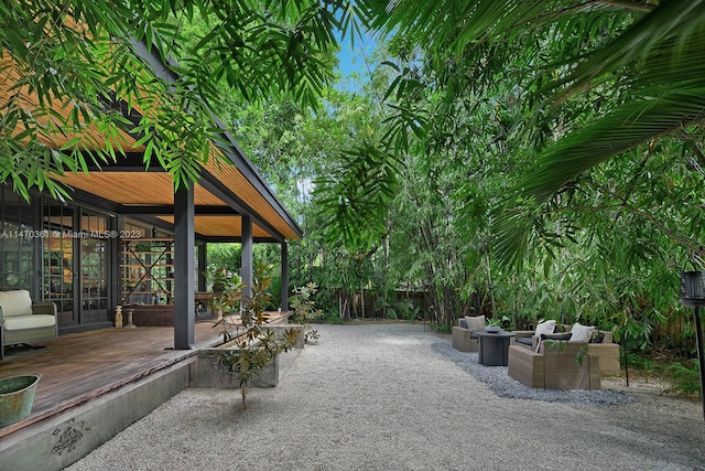 view of patio with an outdoor living space, french doors, and a wooden deck