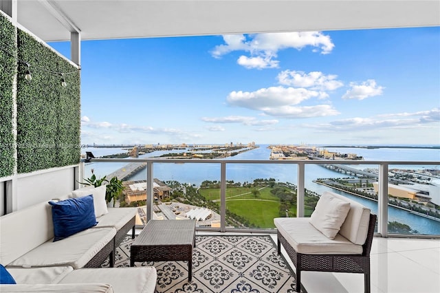 balcony featuring an outdoor hangout area and a water view