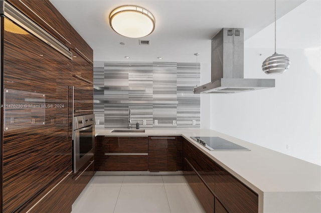 kitchen featuring sink, oven, light tile floors, island exhaust hood, and black electric cooktop