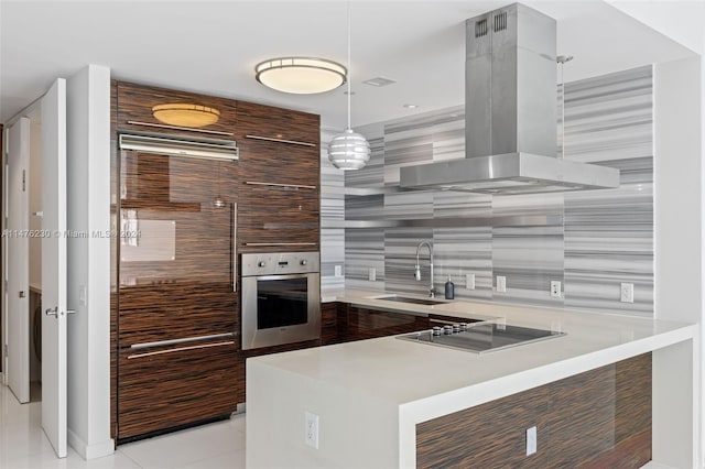 kitchen with oven, sink, light tile floors, ventilation hood, and pendant lighting