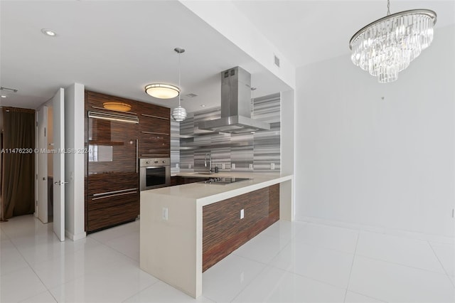 kitchen featuring light tile flooring, pendant lighting, island exhaust hood, and stainless steel oven