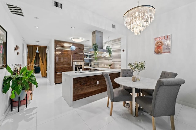 tiled dining room with an inviting chandelier