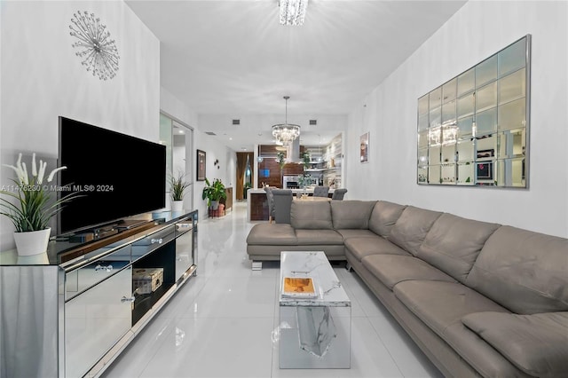 living room featuring light tile floors and a notable chandelier