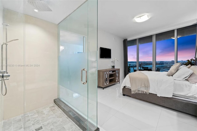 tiled bedroom with access to outside and a water view