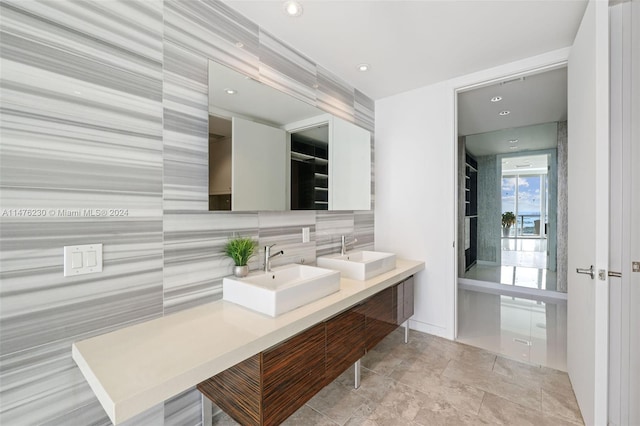 bathroom featuring tasteful backsplash, tile floors, and double sink vanity