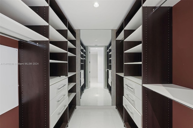 spacious closet with light tile floors