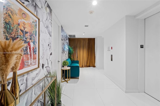 hallway featuring light tile floors