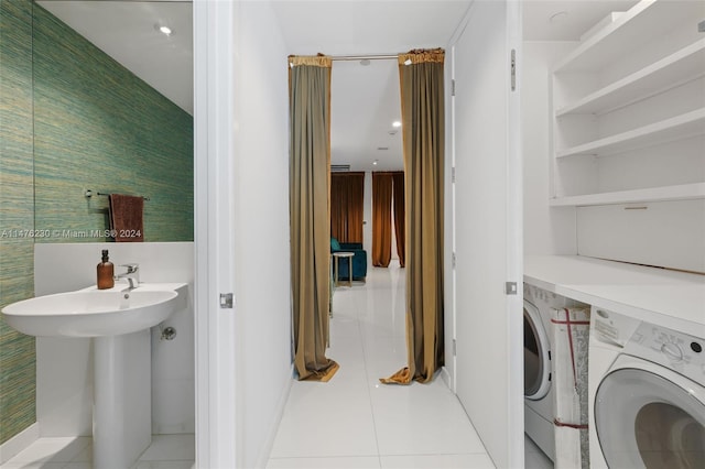 interior space featuring washing machine and clothes dryer and light tile floors