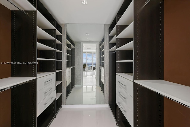 spacious closet with light tile floors