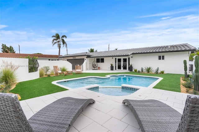 view of pool featuring an in ground hot tub, french doors, a yard, and a patio area