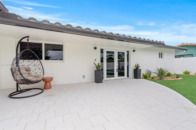 back of property with french doors and a patio area