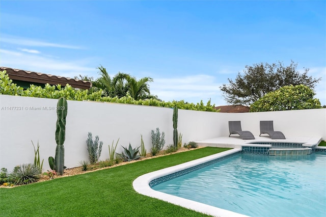 view of pool with a patio and a yard