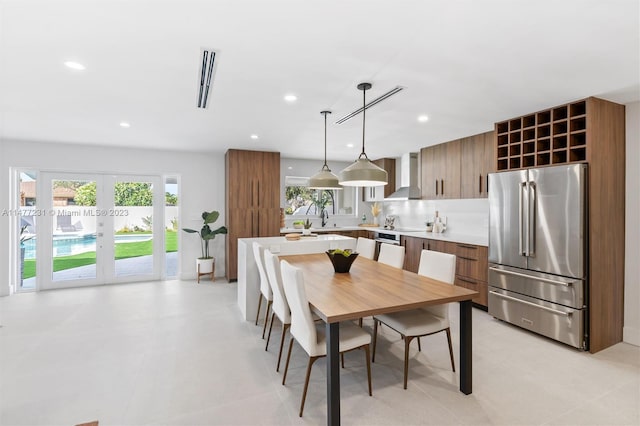 tiled dining space featuring french doors and sink