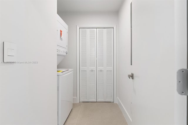 washroom featuring stacked washer / dryer