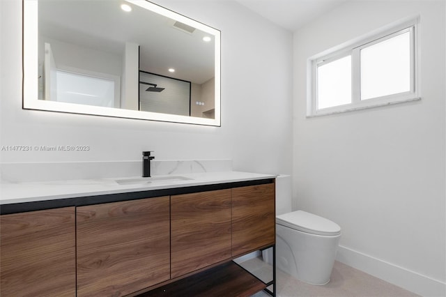 bathroom featuring vanity and toilet