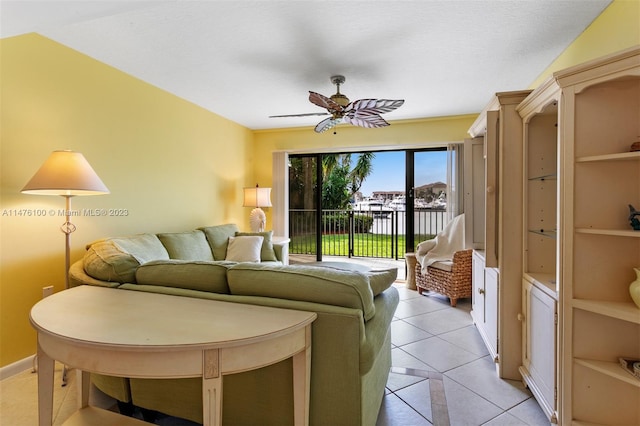 tiled living room with built in features and ceiling fan