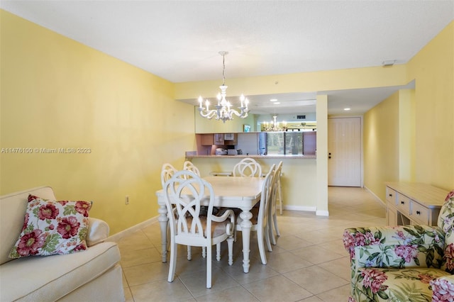 dining area with a chandelier and light tile floors