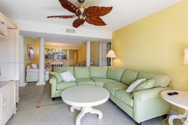 tiled living room featuring ceiling fan with notable chandelier