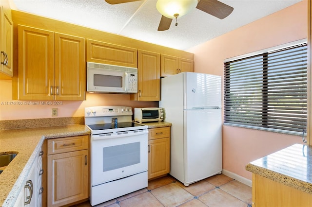 kitchen featuring white appliances, light stone countertops, ceiling fan, and light tile floors