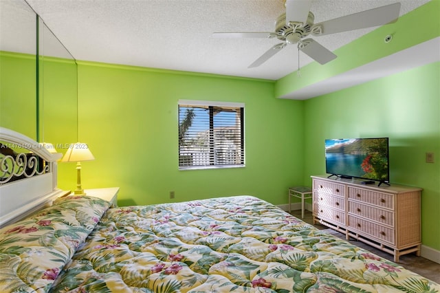 bedroom with a textured ceiling and ceiling fan