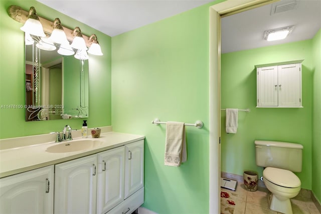 bathroom featuring vanity, tile flooring, a baseboard heating unit, and toilet