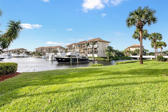 dock area featuring a water view and a yard