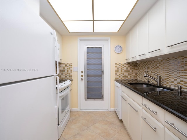 kitchen featuring white cabinetry, white appliances, sink, dark stone countertops, and light tile floors