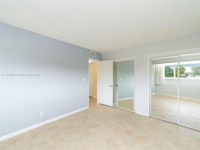 unfurnished bedroom with light tile flooring