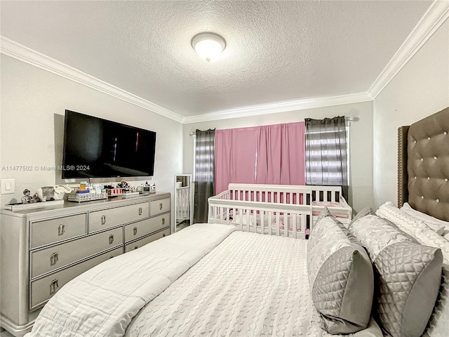 bedroom with a textured ceiling and ornamental molding