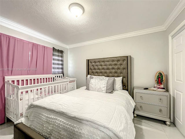 bedroom with a textured ceiling and ornamental molding