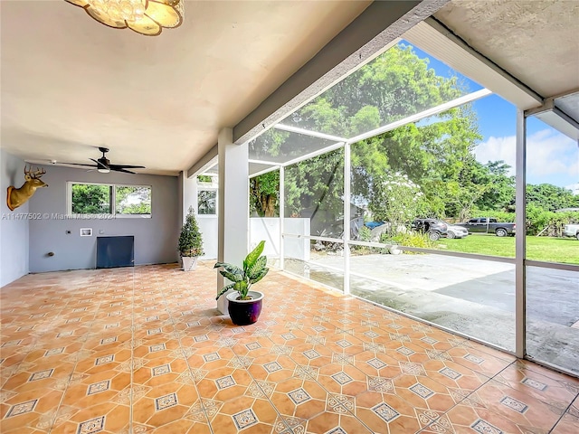 interior space with ceiling fan with notable chandelier