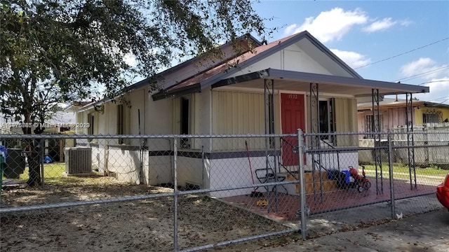 view of side of home featuring covered porch and central air condition unit