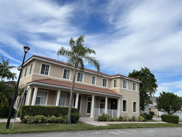 mediterranean / spanish-style house with a porch