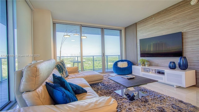 living room featuring floor to ceiling windows and light tile flooring