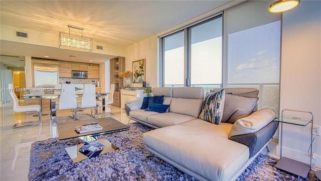 living room featuring an inviting chandelier and light tile flooring