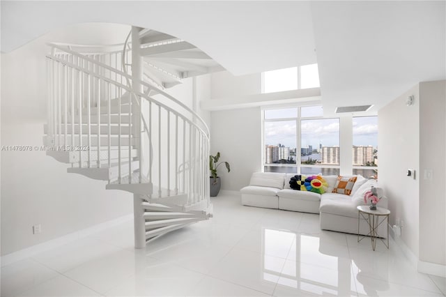 living room with floor to ceiling windows and light tile flooring