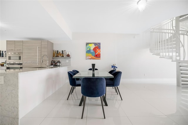 tiled dining space featuring sink