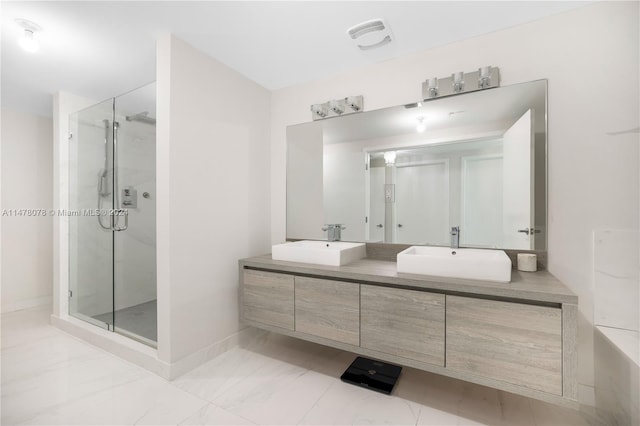 bathroom featuring a shower with shower door, tile flooring, and double sink vanity