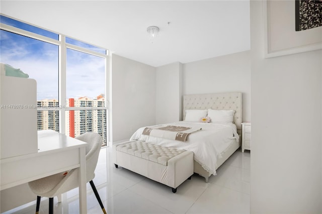 bedroom with floor to ceiling windows and light tile floors