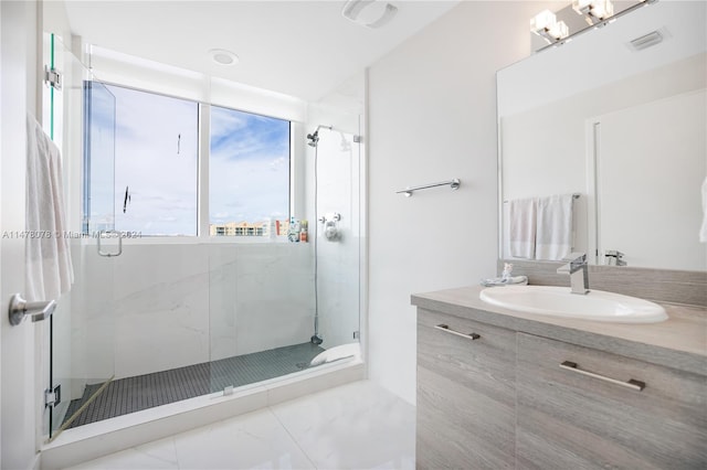 bathroom with walk in shower, an inviting chandelier, tile floors, and vanity with extensive cabinet space