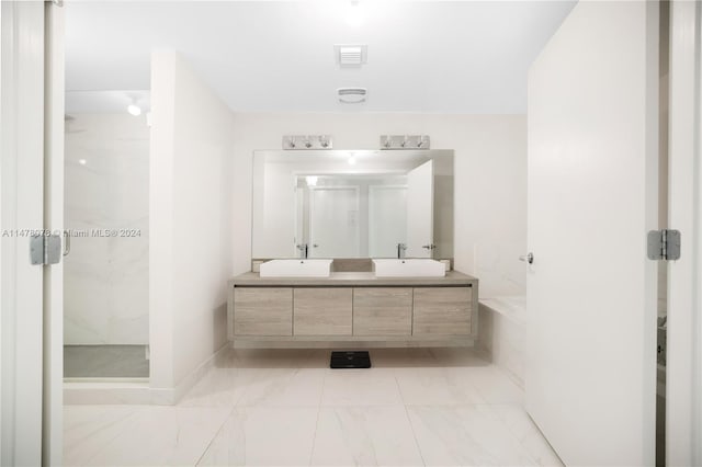 bathroom with a shower with door, tile floors, and dual vanity