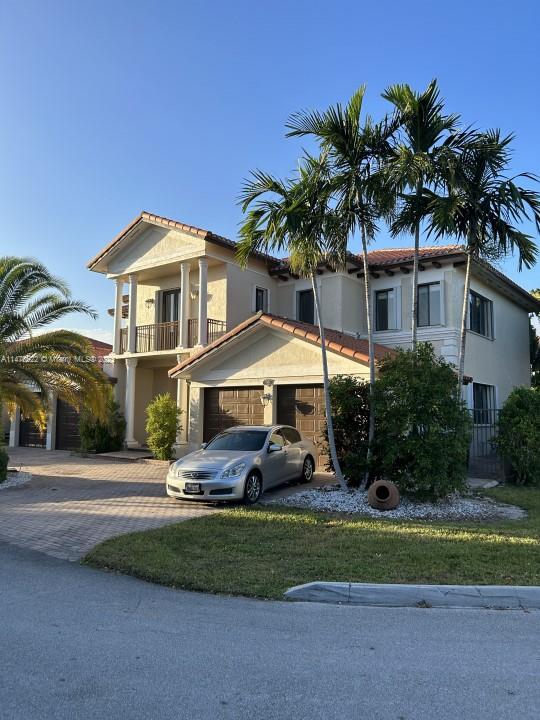 view of front of house featuring a balcony and a garage