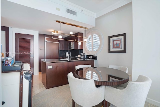 tiled dining area featuring a notable chandelier and crown molding