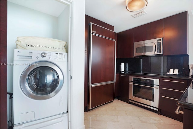 interior space featuring light tile floors and washer / clothes dryer