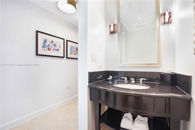 bathroom with vanity and tile flooring