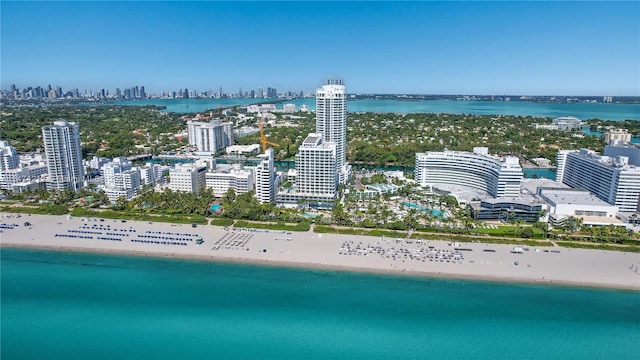 birds eye view of property with a beach view and a water view