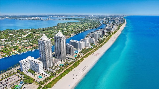 birds eye view of property featuring a water view and a beach view