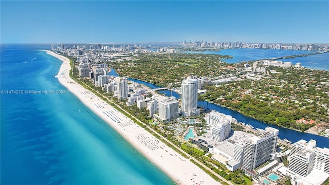 drone / aerial view featuring a water view and a view of the beach