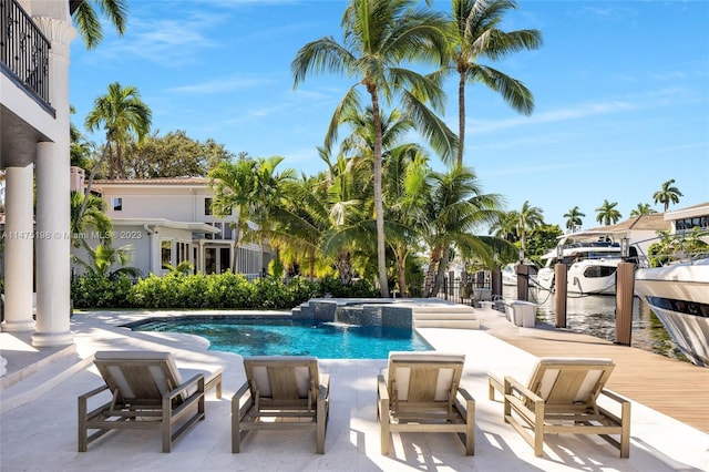 view of swimming pool featuring a patio area and a pool with connected hot tub