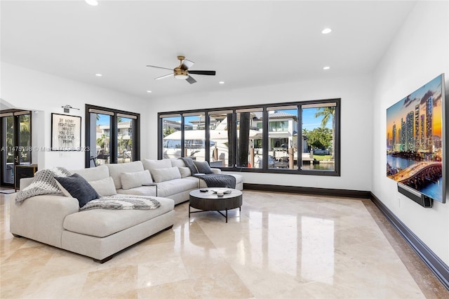 living area featuring baseboards, ceiling fan, and recessed lighting